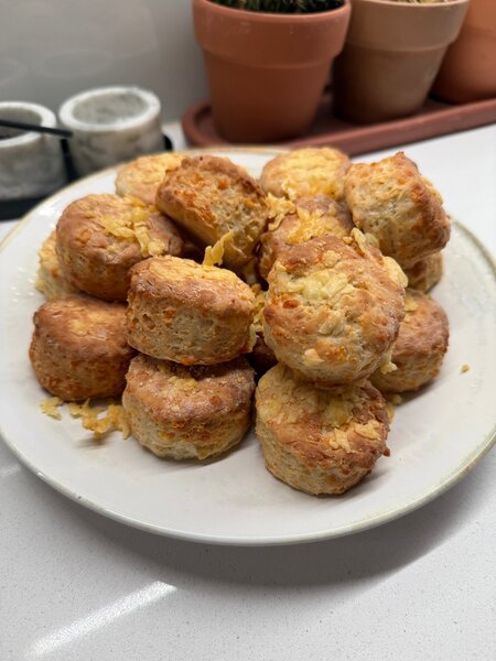 A pile of cheese scones on a plate