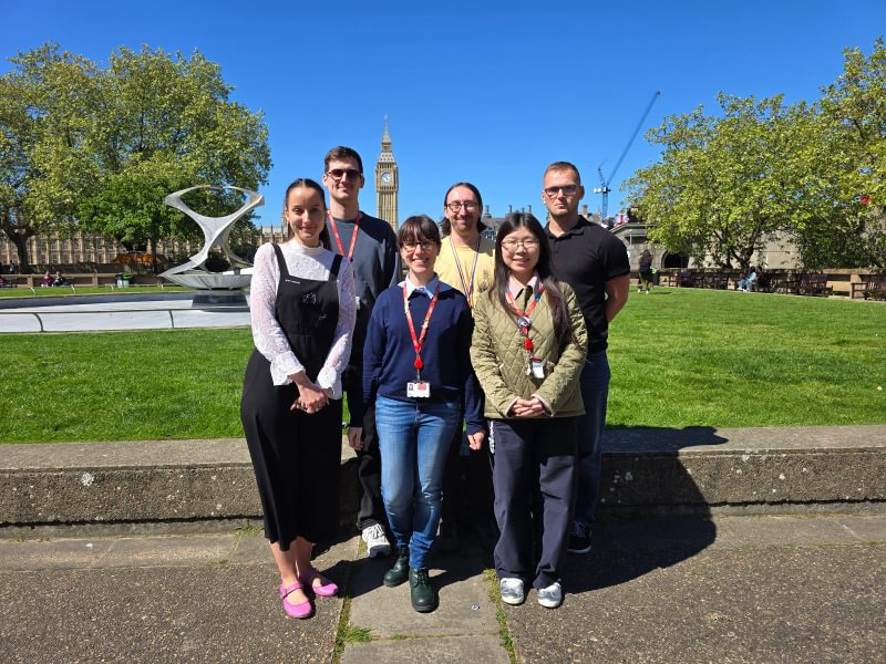 A group of 6 people standing in front of a water feature surrounded by grass. They are all researchers from the Institute of Cancer Research