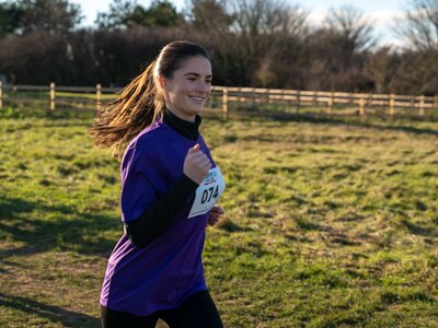 Participants running across the clifftops
