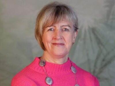 Dr Isabel White in a pink jumper, smiling