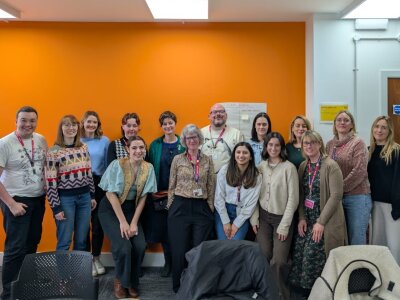 Group photo of Breast Cancer Now's Living with Secondary Breast Cancer team in an office.