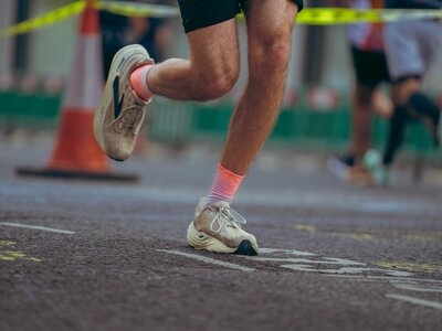 People wearing Breast Cancer Now pink running tops whilst running in the street at the London Landmarks half marathon.