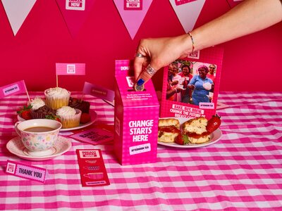 Breast Cancer Now's Afternoon Tea materials on a pink backdrop.
