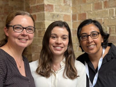 A photo of three researchers, Amy Llewellyn, Kalnisha Naidoo and Sophie Acton, smiling.