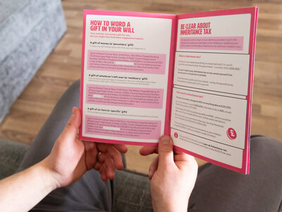 A man is holding Breast Cancer Now's Gifts in Wills booklet open on a page titled 'How to word a gift in your will.'