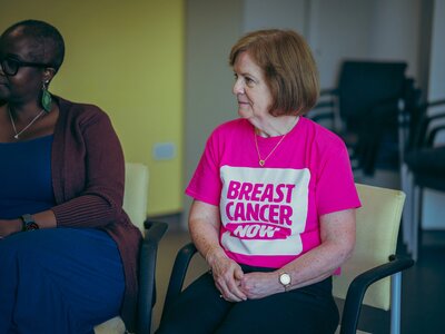 Women attending a Moving Forward course, sat in a circle talking.