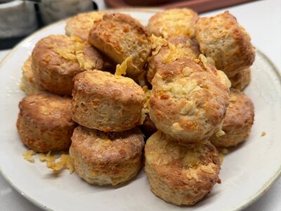 A pile of cheese scones on a plate