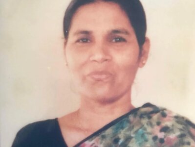 A portrait photo of Amit's mum, Rehka, wearing a floral print sari.