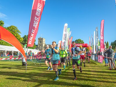Photo of a group of runners setting off from the start line of the Cotswold Way Ultra Challenge on a sunny day.