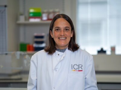 Researchers in white ICR lab coats in posing for photos in a lab.