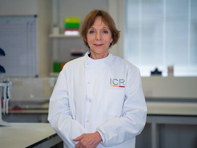 Researchers in white ICR lab coats in posing for photos in a lab.
