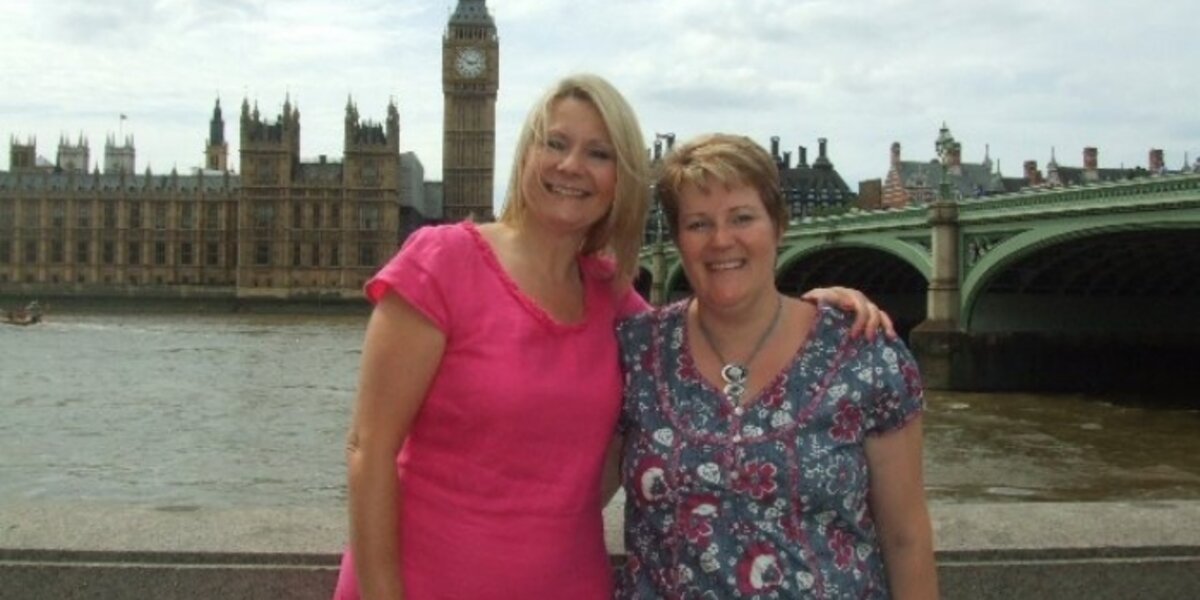 In this image from more than a decade ago, Wendy is wearing a pink dress and has her arm around her late friend, Clare. They were standing in front of the River Thames, with the Houses of Parliament in the background.