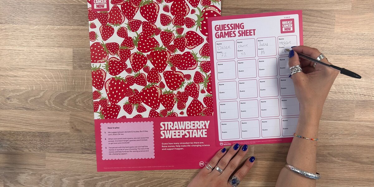 A photo of Breast Cancer Now's Strawberry Sweepstake, and someone filling in the accompanying Guessing Games Sheet.