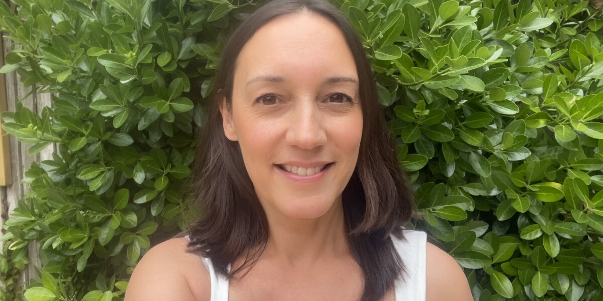 A woman smiling in her garden