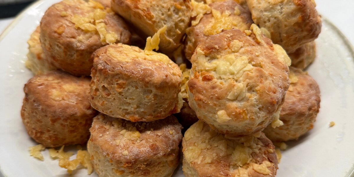 A pile of cheese scones on a plate