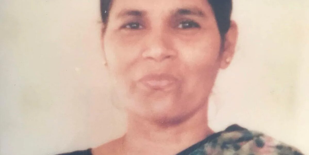 A portrait photo of Amit's mum, Rehka, wearing a floral print sari.