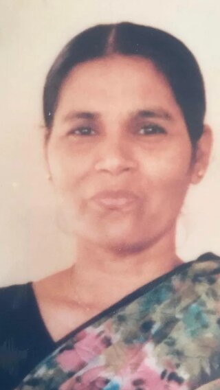 A portrait photo of Amit's mum, Rehka, wearing a floral print sari.