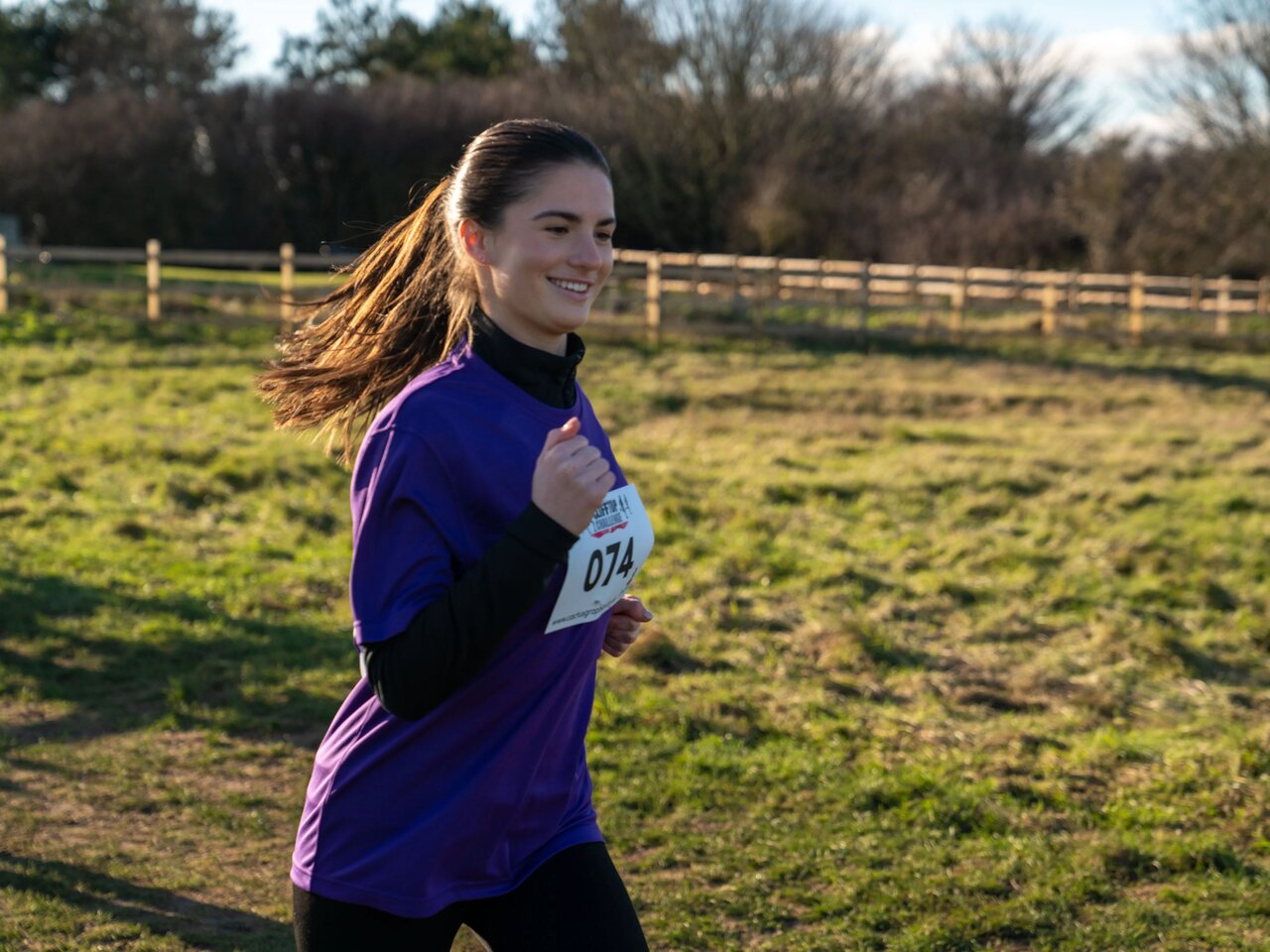 Participants running across the clifftops