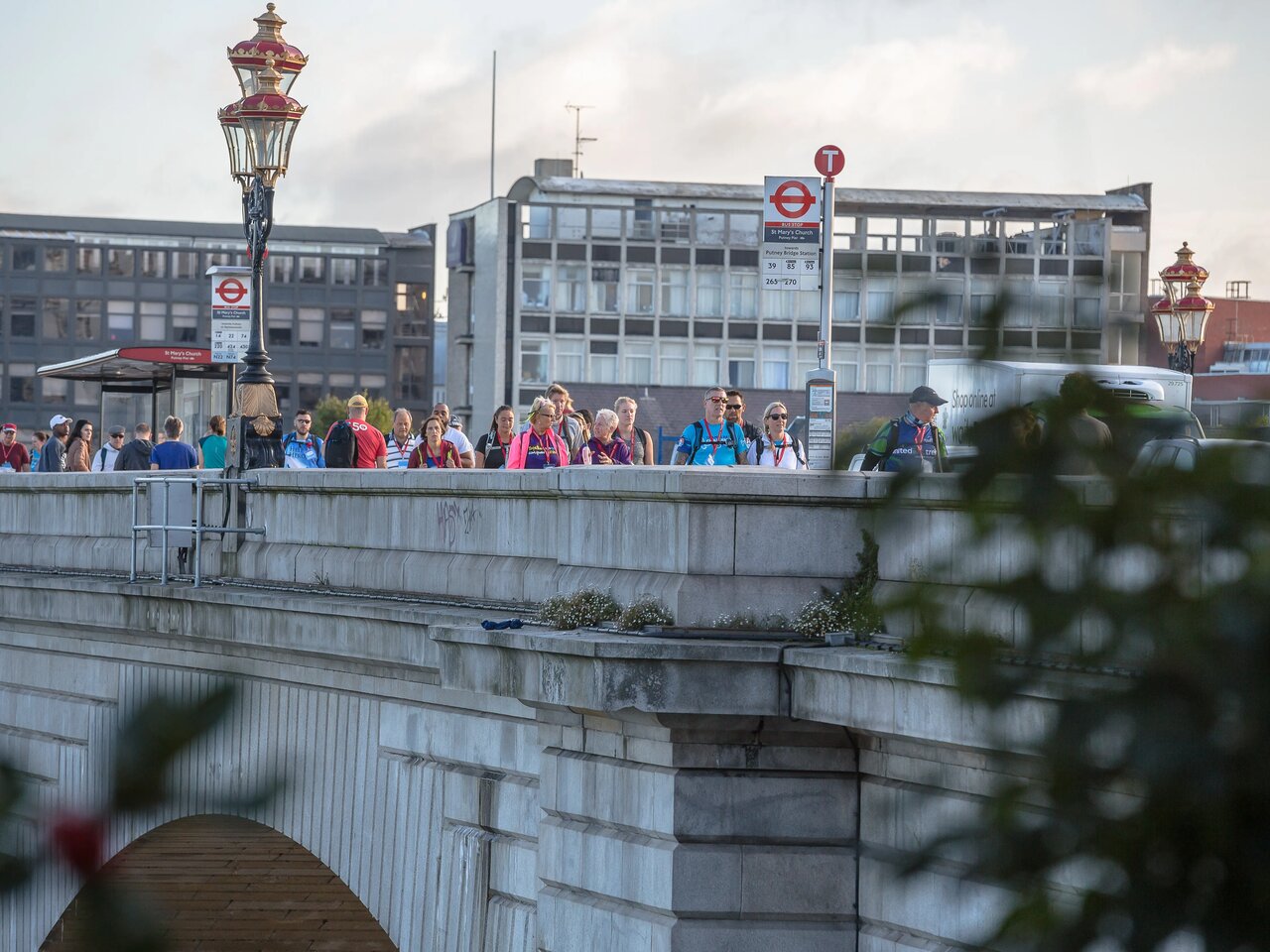 A photo of people crossing Putney Bridge as they take part in the Thames Bridges Trek.