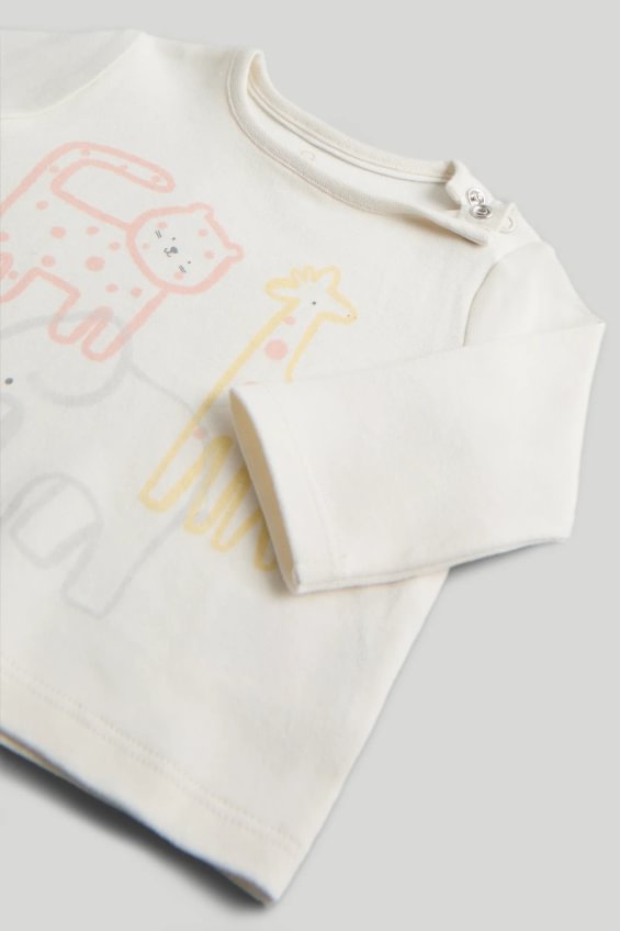 Outfit crem extensibil cu tricou și pantaloni